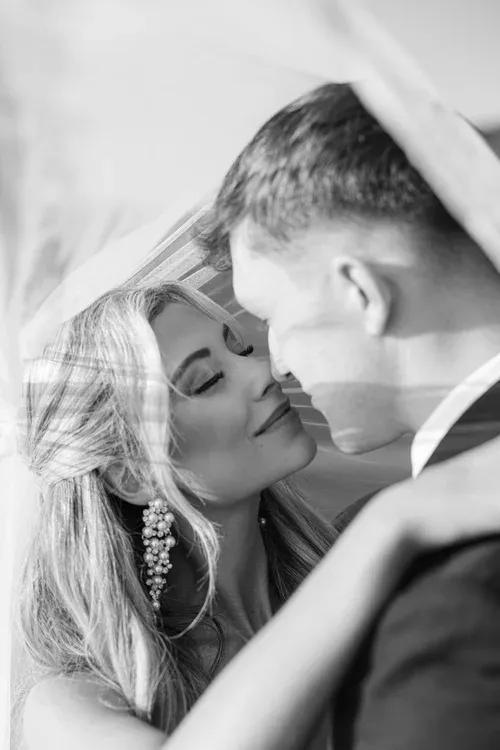 Bride and groom sharing a quiet moment under her veil
